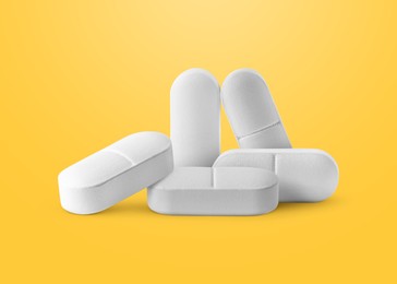 Image of Antibiotic pills. Oval tablets on orange gradient background