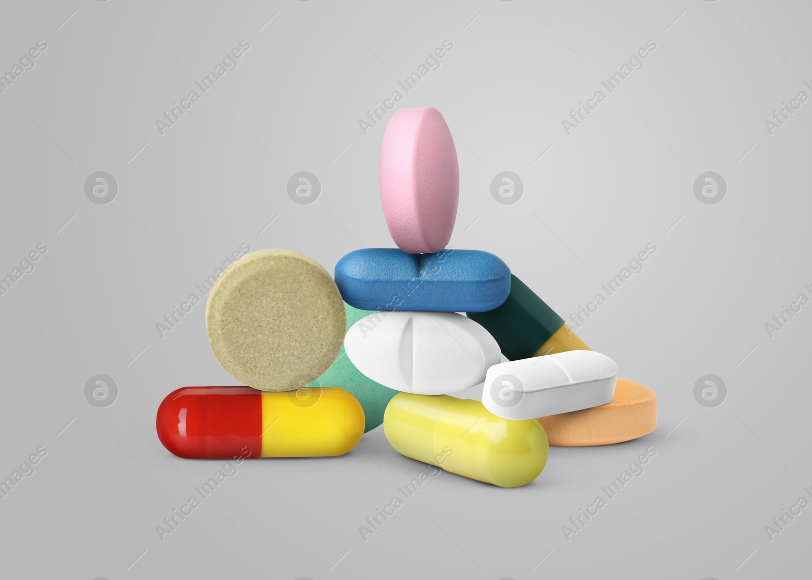 Many different antibiotic pills on grey background Image of Many different antibiotic pills on grey background
