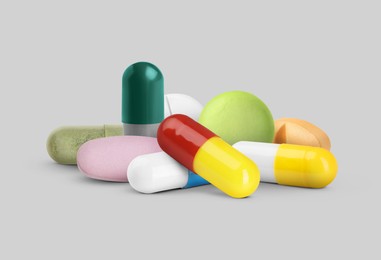 Image of Many different antibiotic pills on grey background