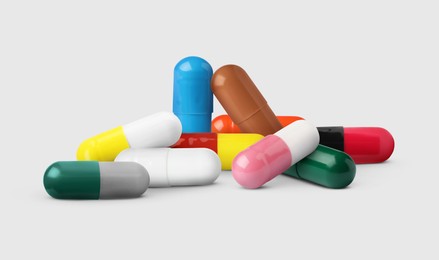 Image of Different antibiotic pills on light grey background. Banner design