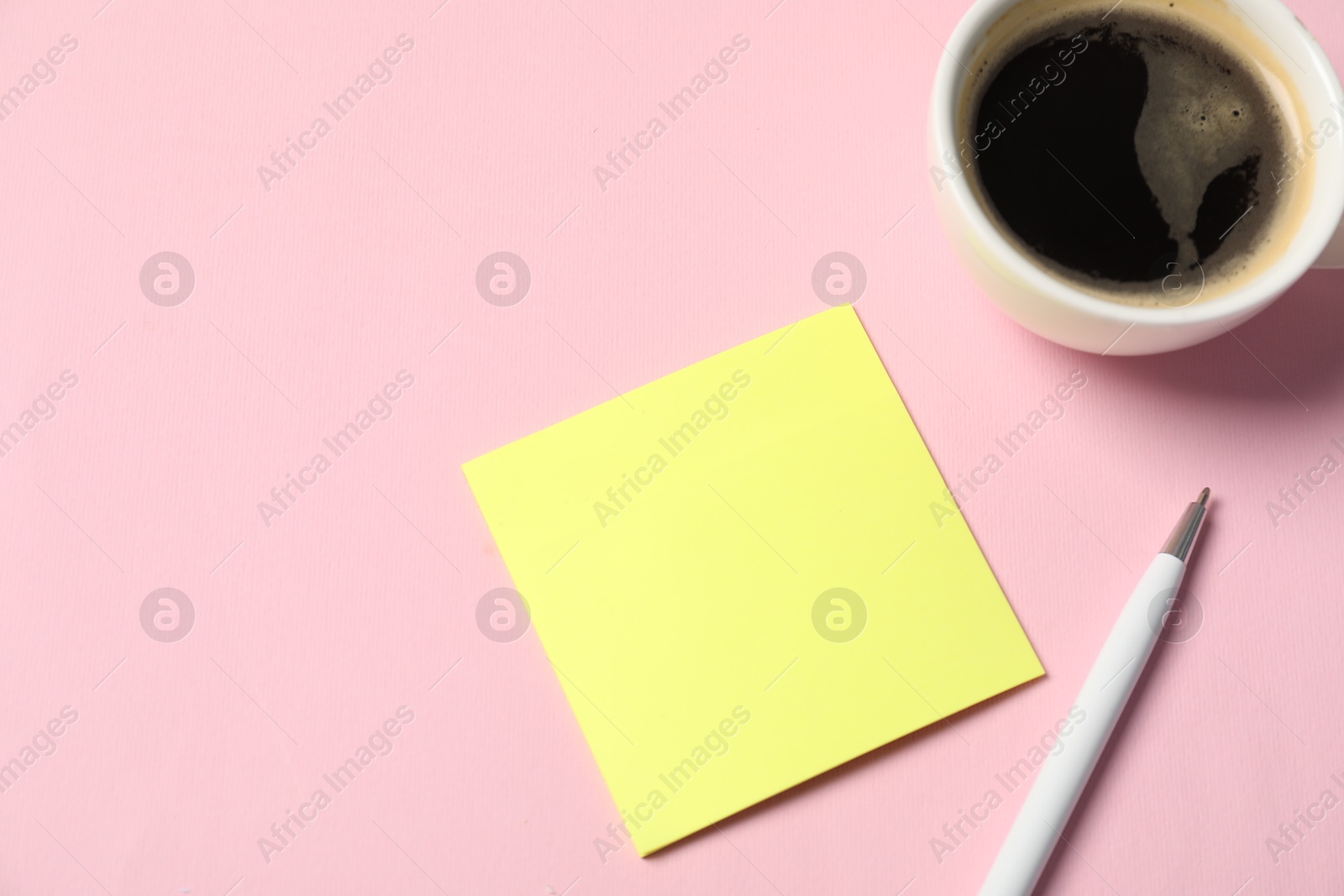 Sticky note, pen and coffee on pink background, closeup. Space for text Photo of Sticky note, pen and coffee on pink background, closeup. Space for text