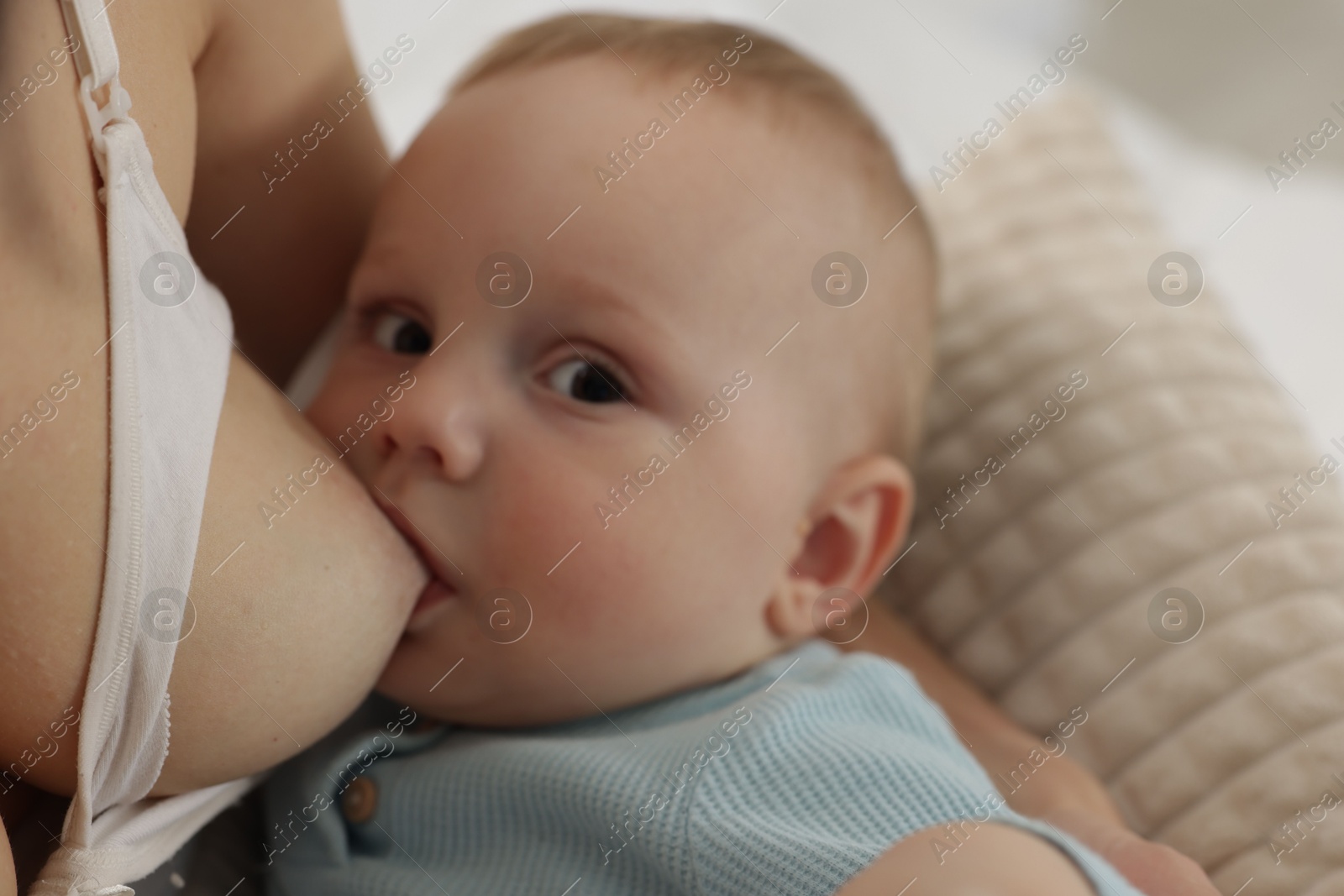 Mother breastfeeding her little baby indoors, closeup Photo of Mother breastfeeding her little baby indoors, closeup