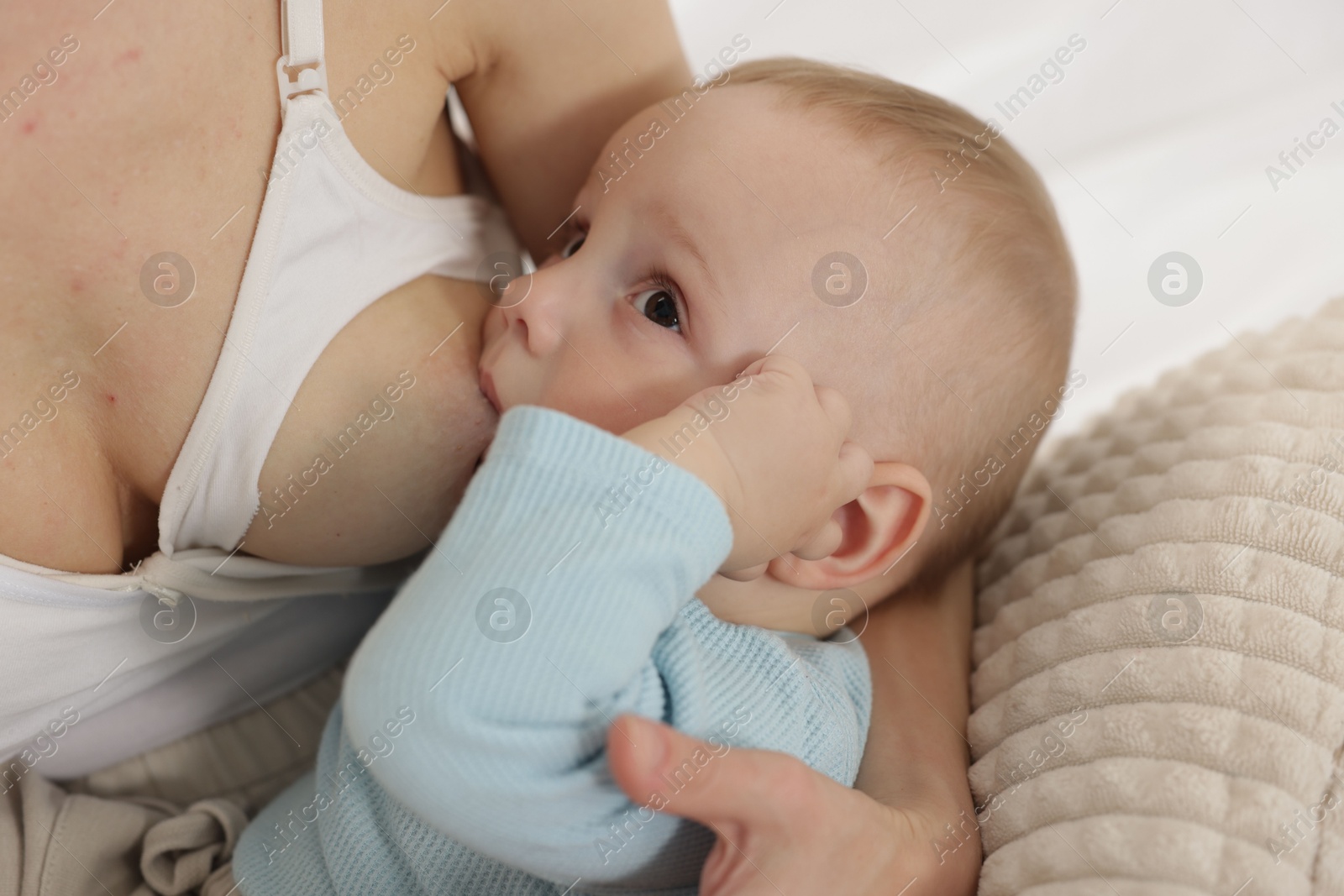 Mother breastfeeding her little baby indoors, closeup Photo of Mother breastfeeding her little baby indoors, closeup