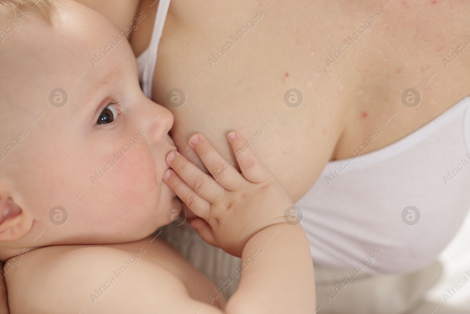 Mother breastfeeding her little baby indoors, closeup Photo of Mother breastfeeding her little baby indoors, closeup