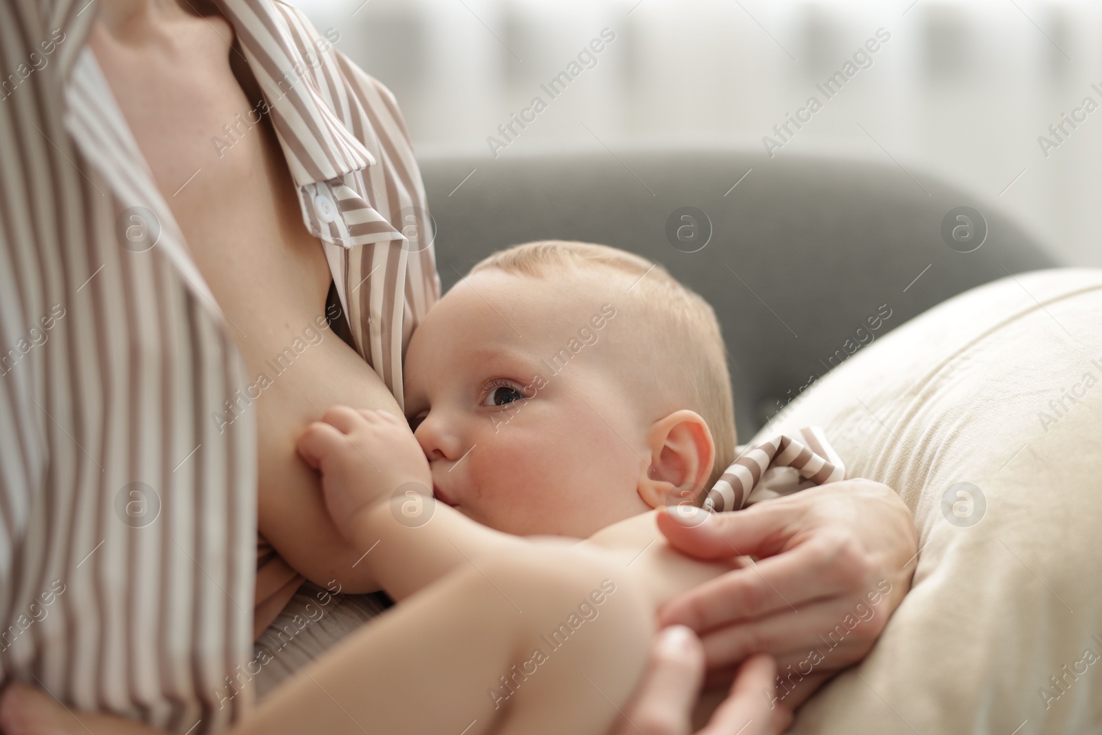 Mother breastfeeding her little baby indoors, closeup Photo of Mother breastfeeding her little baby indoors, closeup