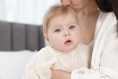 Photo of Mother kissing her little baby at home, closeup