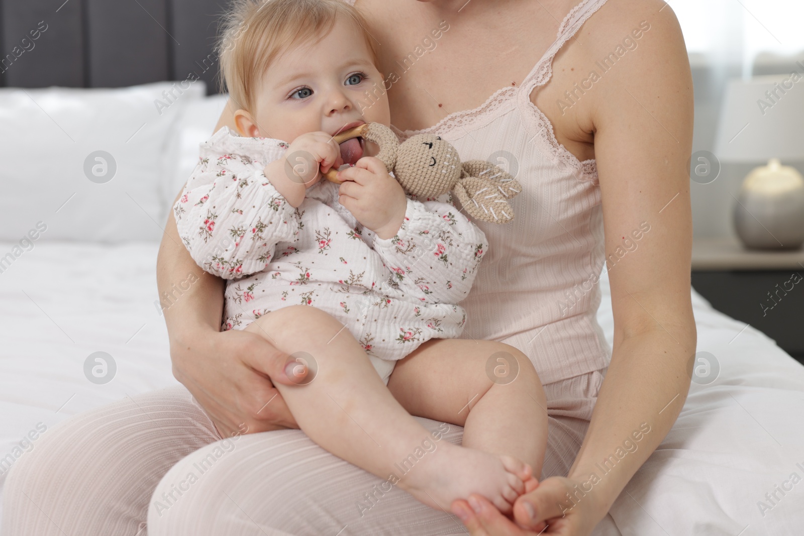 Mother with her little baby on bed at home, closeup Photo of Mother with her little baby on bed at home, closeup