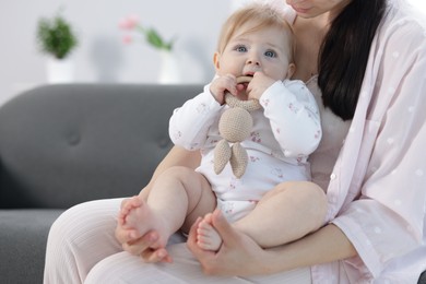 Photo of Mother with her little baby at home, closeup