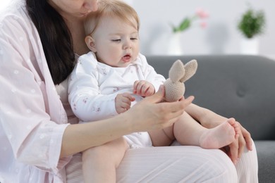 Photo of Mother with her little baby at home, closeup