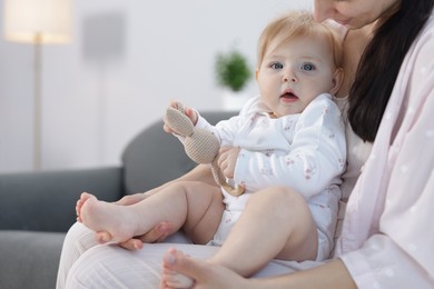 Photo of Mother with her little baby at home, closeup