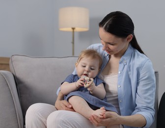 Photo of Mother with her little baby on armchair indoors