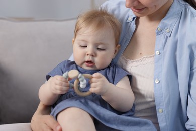 Photo of Mother with her little baby on armchair indoors, closeup