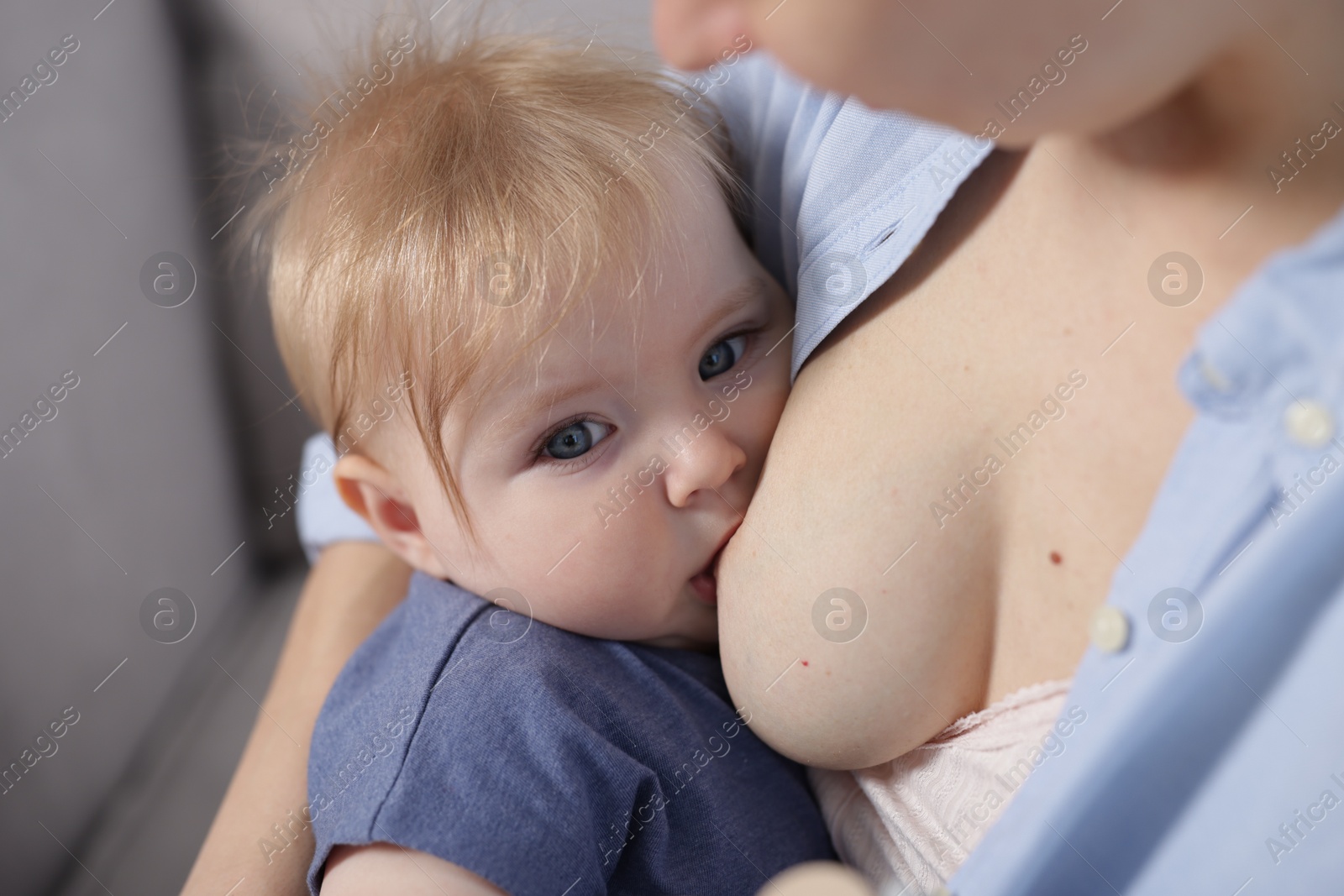 Mother breastfeeding her little baby indoors, closeup Photo of Mother breastfeeding her little baby indoors, closeup
