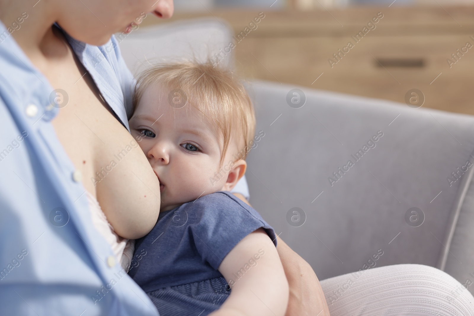 Mother breastfeeding her little baby indoors, closeup Photo of Mother breastfeeding her little baby indoors, closeup