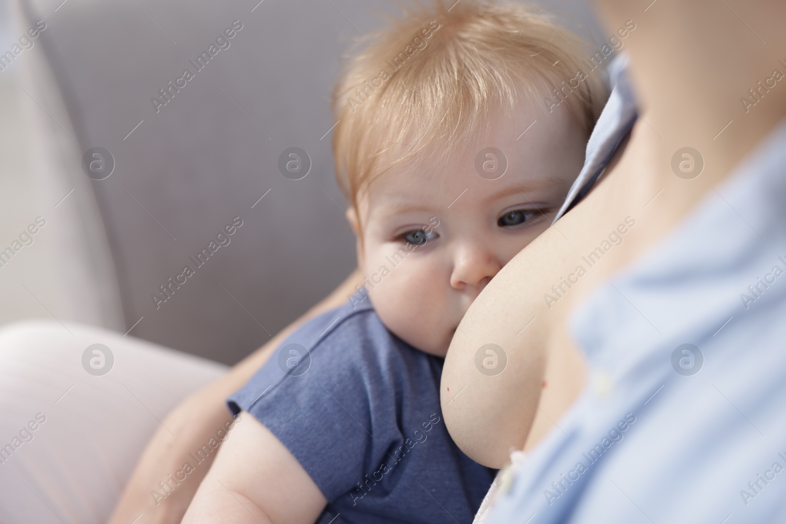 Mother breastfeeding her little baby indoors, closeup Photo of Mother breastfeeding her little baby indoors, closeup