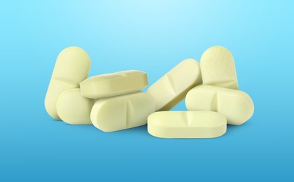 Image of Antibiotic pills. Yellow tablets on light blue gradient background. Banner design