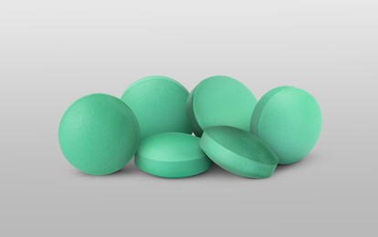 Image of Antibiotic pills. Round tablets on grey gradient background. Banner design