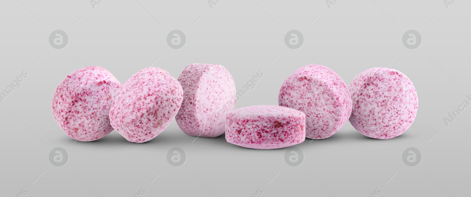 Antibiotic pills. Round pink tablets on light grey background. Banner design Image of Antibiotic pills. Round pink tablets on light grey background. Banner design