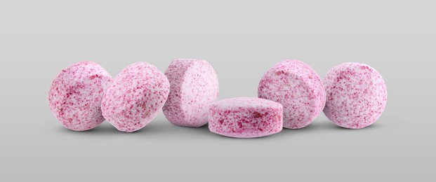 Image of Antibiotic pills. Round pink tablets on light grey background. Banner design