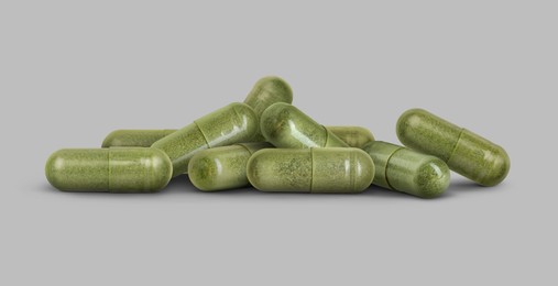 Image of Antibiotic pills. Green capsules on grey background. Banner design