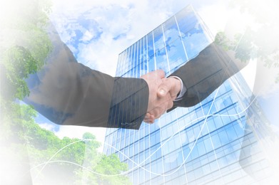 Image of Businesspeople shaking hands, cityscape and graph, multiple exposure. Deal or partnership concept