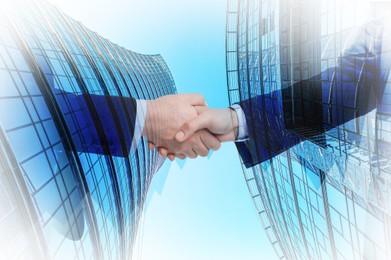 Image of Double exposure with cityscape and photo of businesspeople shaking hands. Deal or partnership concept
