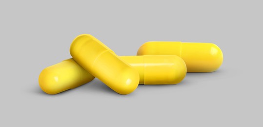 Image of Antibiotic pills. Yellow capsules on grey background. Banner design