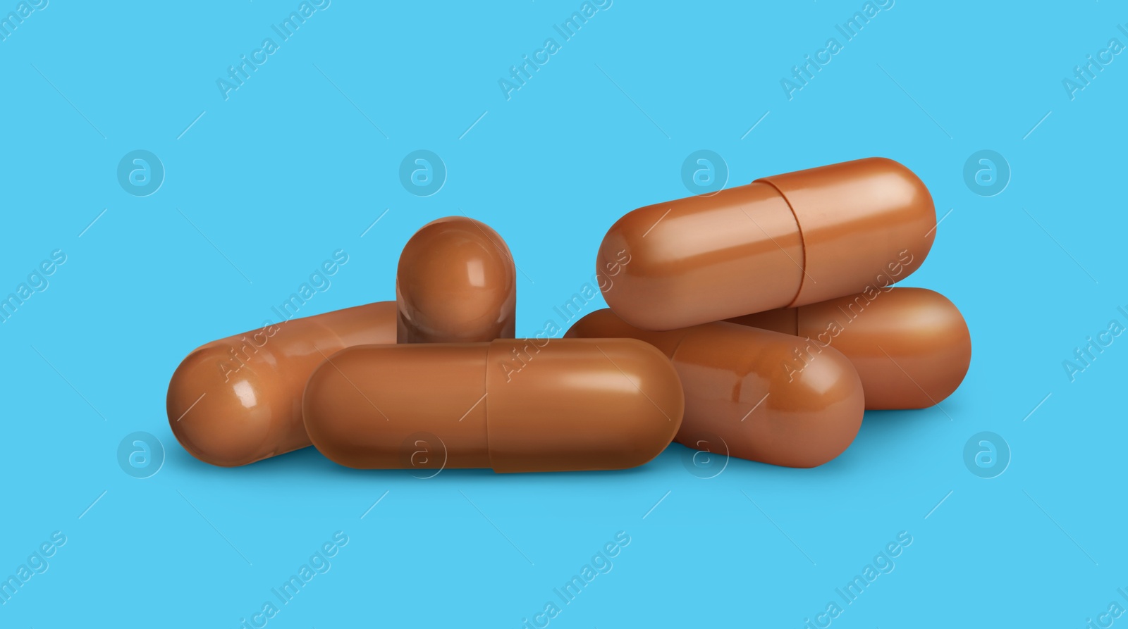 Antibiotic pills. Brown capsules on light blue background. Banner design Image of Antibiotic pills. Brown capsules on light blue background. Banner design