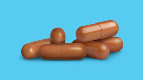 Image of Antibiotic pills. Brown capsules on light blue background. Banner design
