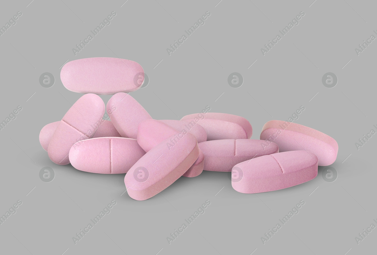Antibiotic pills. Oval pink tablets on grey background Image of Antibiotic pills. Oval pink tablets on grey background