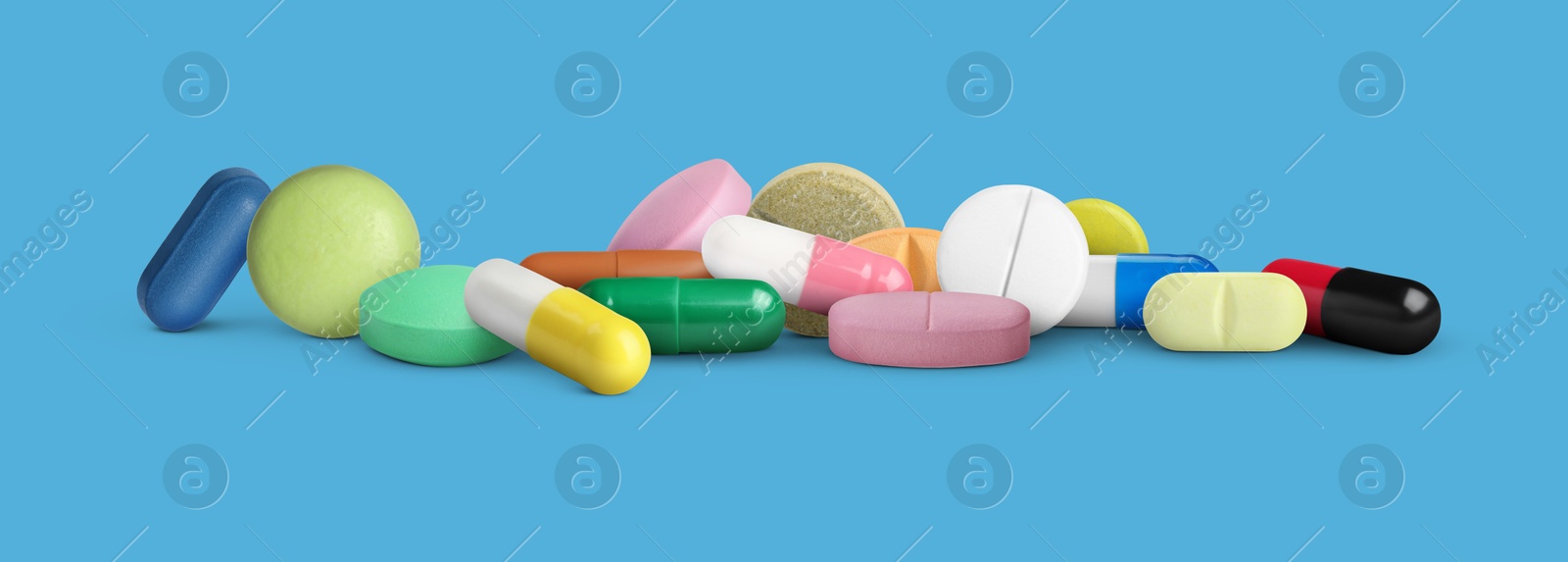 Different antibiotic pills on light blue background. Banner design Image of Different antibiotic pills on light blue background. Banner design