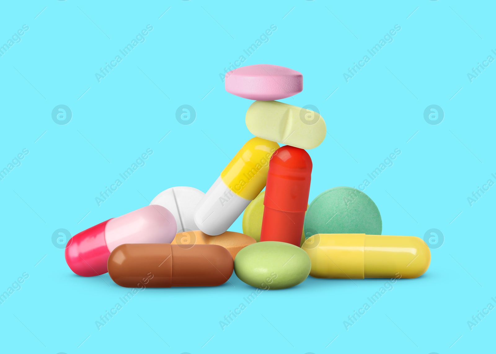 Different antibiotic pills on light blue background Image of Different antibiotic pills on light blue background