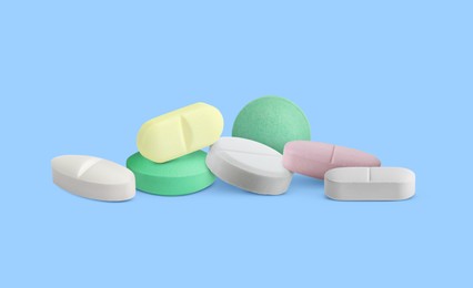 Image of Different antibiotic pills on light blue background. Banner design