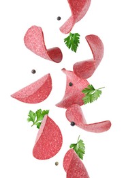 Image of Salami sausage slices, peppercorns and parsley flying on white background