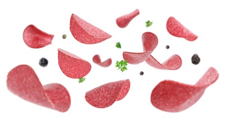 Image of Salami sausage slices, peppercorns and parsley flying on white background