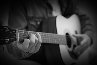 Image of Man playing guitar, closeup. Black and white effect