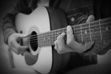 Image of Man playing guitar, closeup. Black and white effect