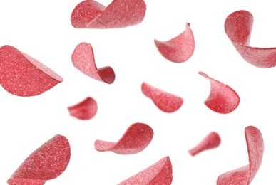Image of Salami sausage slices flying on white background