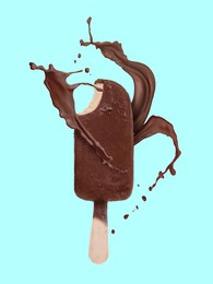 Image of Chocolate ice cream bar and splash of milk on light blue background
