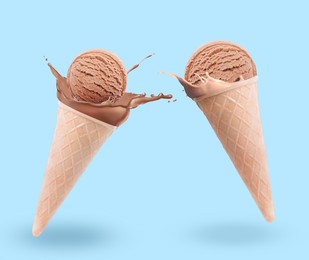 Image of Chocolate ice cream in waffle cones and splash of milk on light blue background