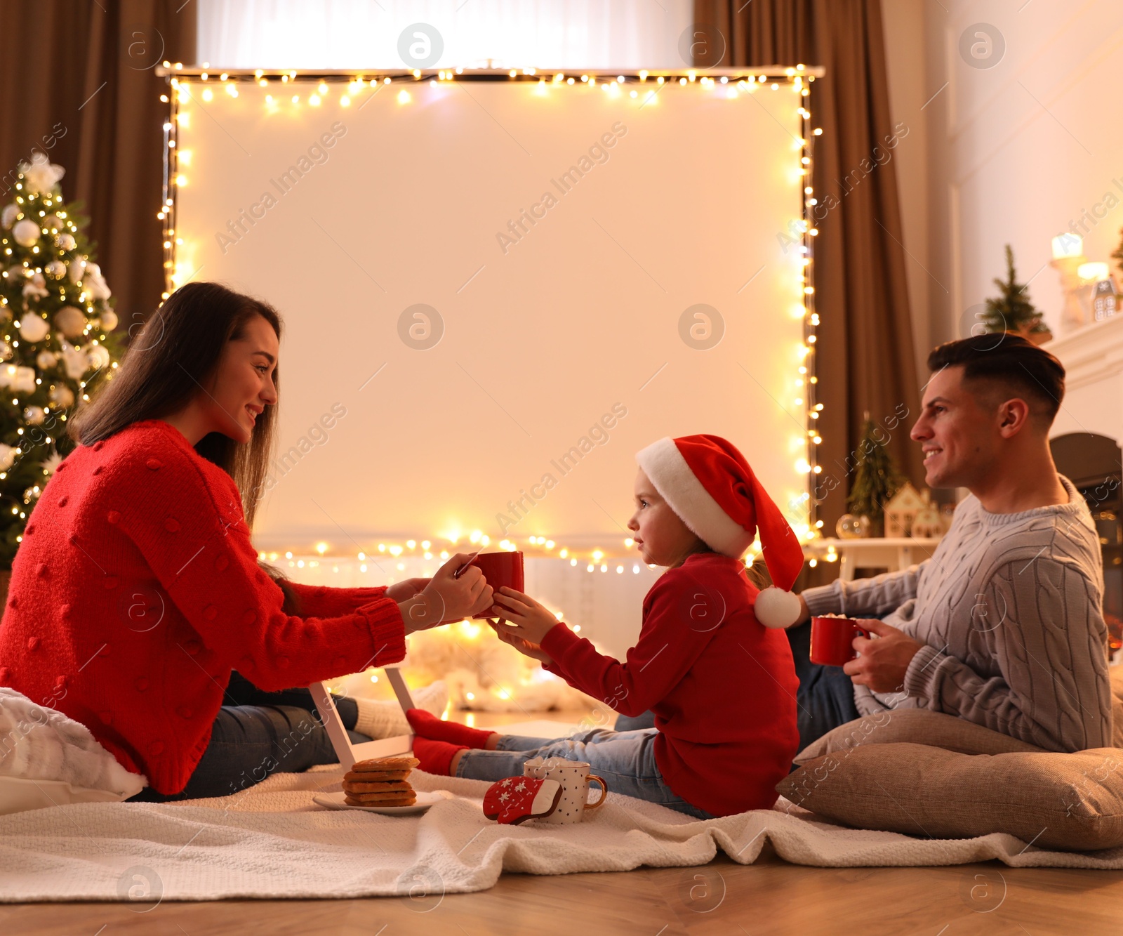 Family near video projector screen at home. Christmas time Photo of Family near video projector screen at home. Christmas time