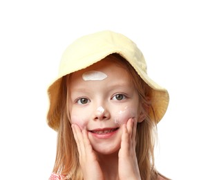 Photo of Smiling little girl applying sun protection cream onto her skin against white background