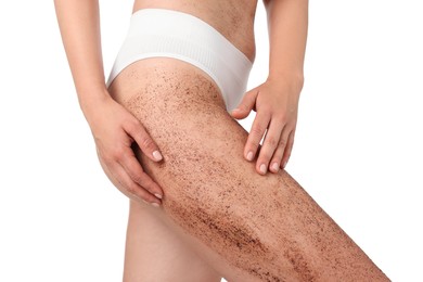 Photo of Woman with body scrub on her leg against white background, closeup