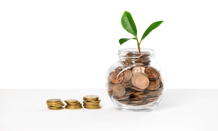 Photo of Investment concept. Glass jar with coins and sprout on light background, space for text