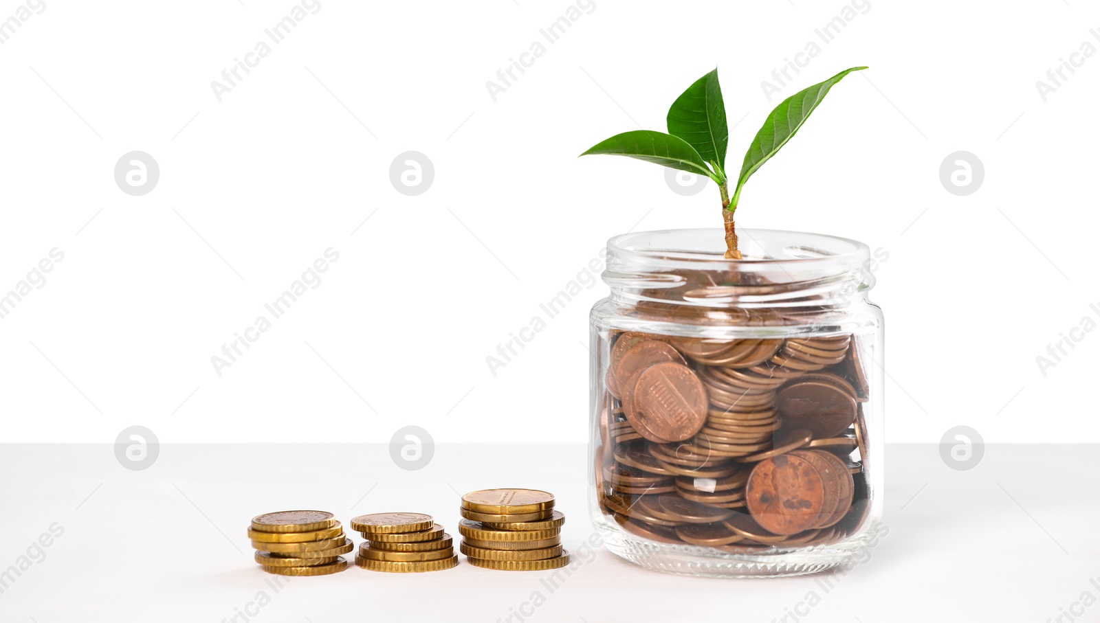 Investment concept. Glass jar with coins and sprout on light background, space for text Photo of Investment concept. Glass jar with coins and sprout on light background, space for text