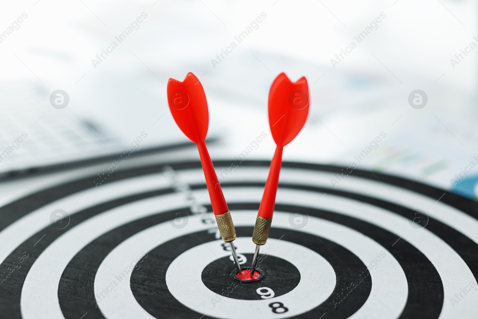 Photo of Dartboard with arrow on table indoors, closeup