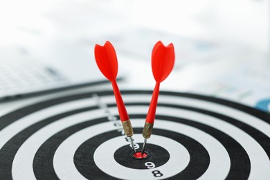 Photo of Dartboard with arrow on table indoors, closeup