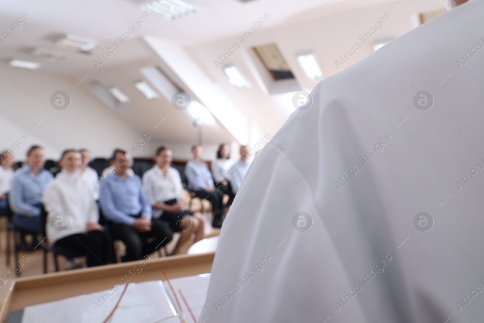 Photo of Doctor giving lecture during medical conference in meeting room, closeup