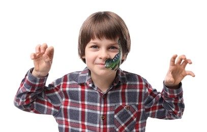 Photo of Cute boy with dinosaur face painting posing on white background