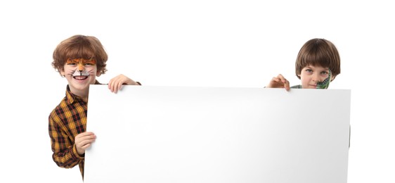 Photo of Cute boys with colorful face paintings and blank banner on white background. Space for text